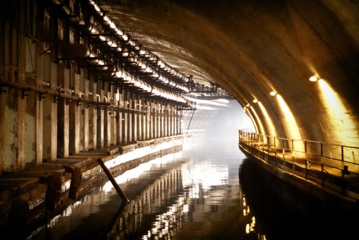 Balaklava, Crimea - 22 June 2007: - Classified military object K-825 - underground submarine base and weapons during Cold War in Sevastopol. Underwater Channel in the grotto, where to hide submarines