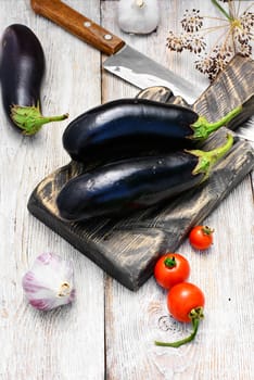 Harvest vegetables aubergine on wooden background in rustic style