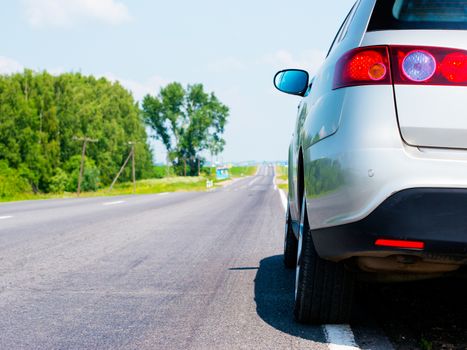 Car on asphalt country road in summer