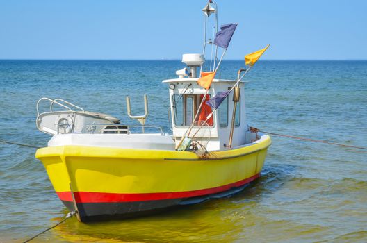 White yellow  fishing boat on alongshore