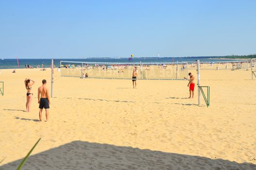 Sopot-Poland June-2016  Group young friends playing volleyball on beach against Baltic sea.