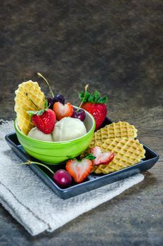 Vanilla ice cream scoops with fresh berries fruit