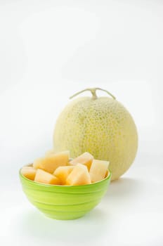 Ripe melon with slice on white background