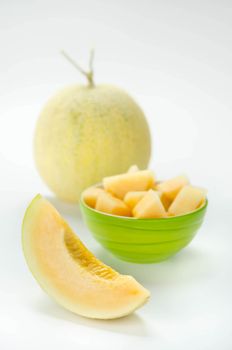 Ripe melon with slice on white background