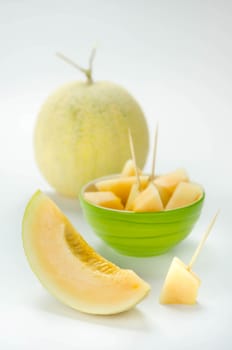 Ripe melon with slice on white background