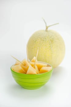 Ripe melon with slice on white background