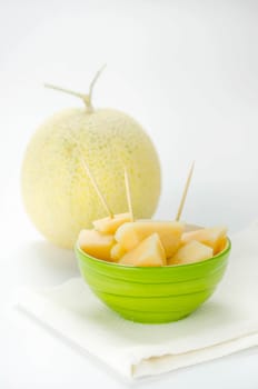 Ripe melon with slice on white background