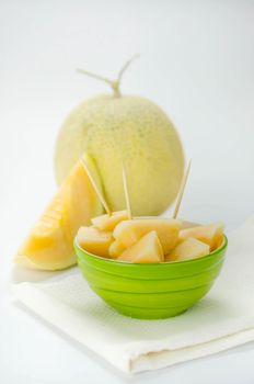 Ripe melon with slice on white background