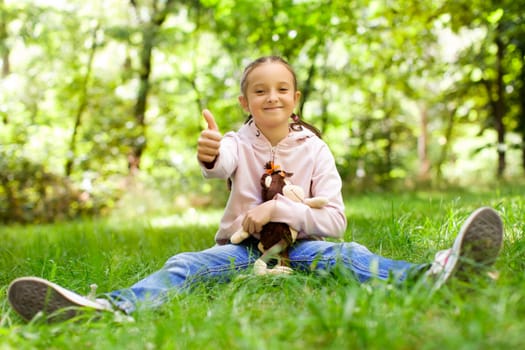 Girl sitting on green grass on a sunny day