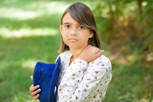 Portrait of a girl outdoors in summer sunny day