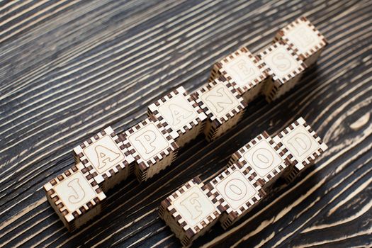 Wooden blocks with the English alphabet, Japanese food