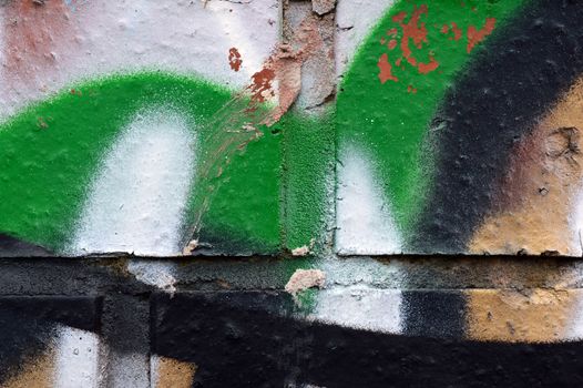 A closeup shot of graffiti detail on a brick wall