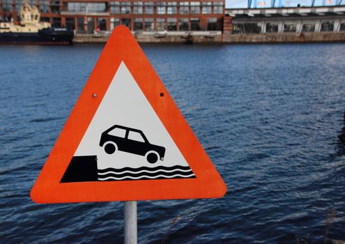 Warning Sign Car Driving into Harbor on Harbor Water Background