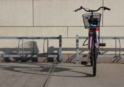 Single Bicycle in Steel Bike Mounted Parking Rack with Shadow