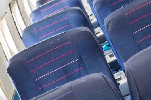 Empty old blue airplane seats in the cabin, selective focus
