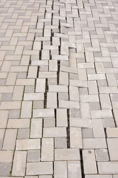 A large crack in the paving tiles