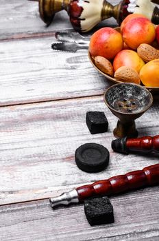 Details Eastern smoking hookah with fruit apricot