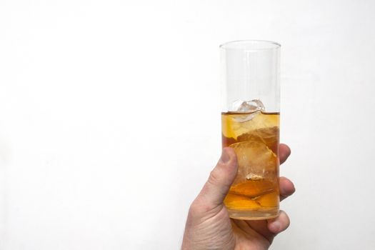 man holding glass of alcoholic drink