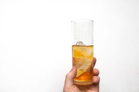 man holding glass of alcoholic drink