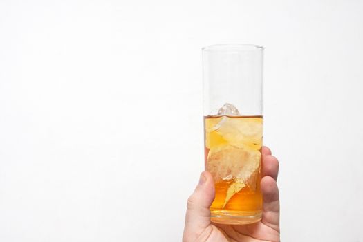 man holding glass of alcoholic drink