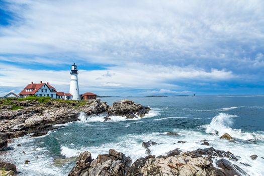 A view of the Portland Head Light following a summer afternoon rainstorm along the rocky Maine coastline.