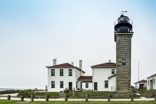 View of the Beavertail Light lighthouse near Jamestown on Conanicut Island, Rhode Island, with a bright blue sky