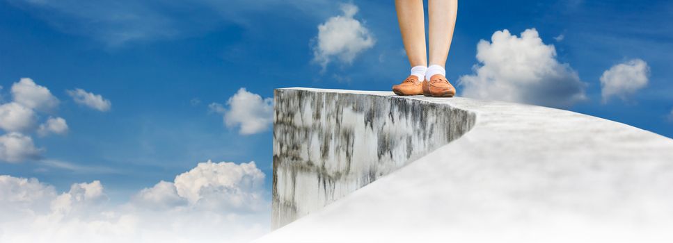 Women leg walking back from dead end on high way footpath or top of wall and cloudy sky view background