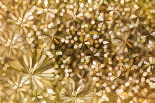 Abstract background flower shape golden glitter bokeh 