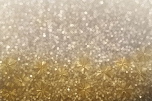 Lovely glitter shining abstract blossom flower shape on mini gold and platinum bokeh background