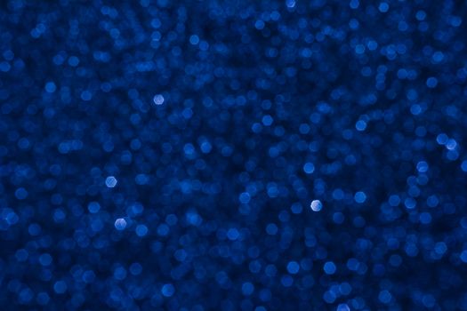 Small bokeh light sparkle shining on dark blue background