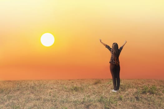 women raise two arms embraces sunrise and fresh nature, concept of freedom and happiness 