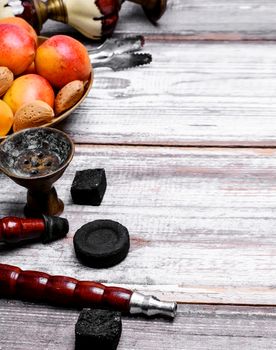 Details Eastern smoking hookah with fruit apricot