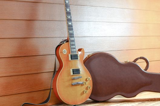 Electric Guitar and case in wood room