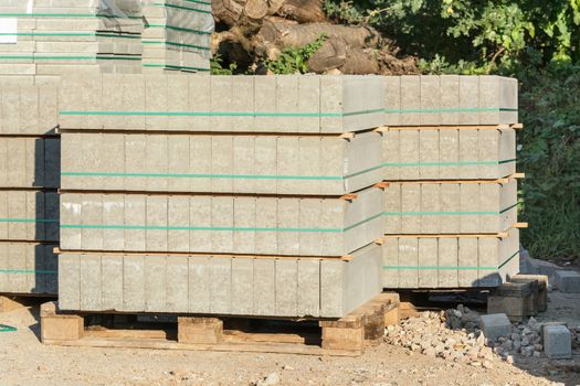 Building material: Stacked paving stones on wooden pallet.