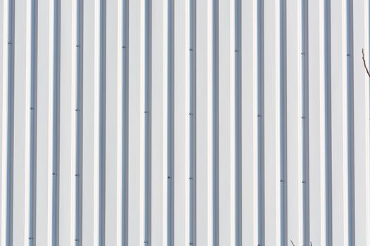 Silver-colored metal wall corrugated sheet metal background.