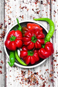 Set of red pepper and paprika on iron plate with bright light background with spices