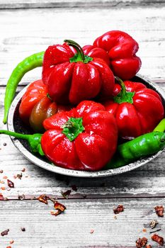 Set of red pepper and paprika on iron plate with bright light background with spices