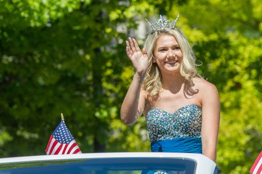 BOISE, IDAHO - JULY 4, 2016: Woman waving to the crowd during the Boise 4th of July parade