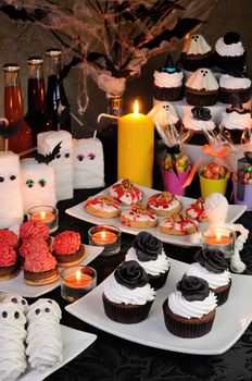 Table served with a variety of sweets and drinks on Halloween