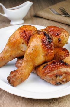 Baked chicken leg with tomato sauce on a plate