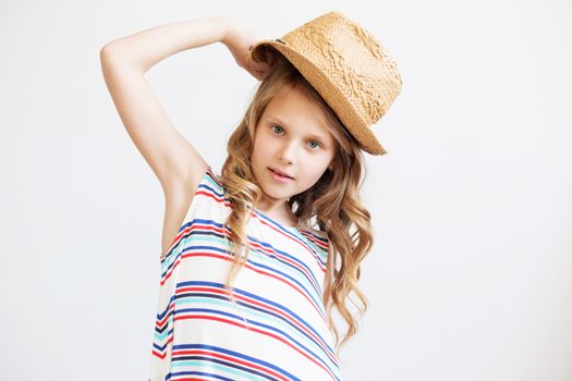 lovely little girl with straw hat against a white background