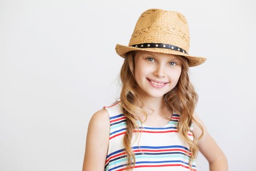 lovely little girl with straw hat against a white background. Smiling kids
