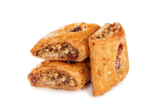 East dessert made of phyllo pastry filled with chopped nuts and soaked in honey. Baklava isolated on white background. Flaky pastry dough with nuts soaked in sweet syrup