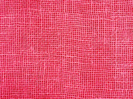 Natural pink cotton fabric weaving close up as background texture