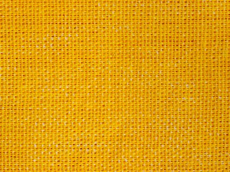 Natural yellow cotton fabric weaving close up as background texture