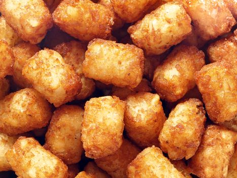 close up of rustic golden potato tater tots food background