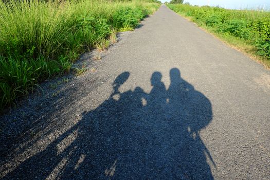 Amazing silhouette of couple on countryside road, summer  journey of backpacker of motorcycle to adventure Vietnam landscape, strong man ride motor on street, Asia couple travel together by motorbike