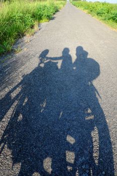 Amazing silhouette of couple on countryside road, summer  journey of backpacker of motorcycle to adventure Vietnam landscape, strong man ride motor on street, Asia couple travel together by motorbike