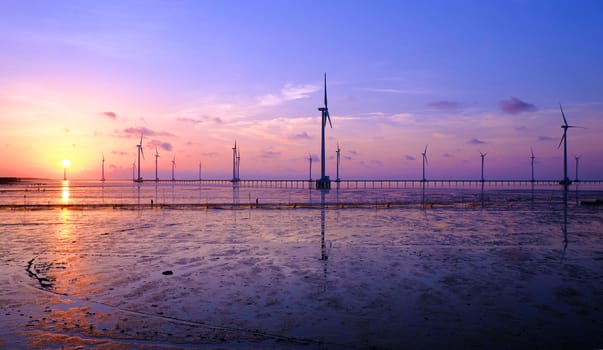 Group of wind turbines of Bac Lieu wind power plant at Mekong Delta, Vietnam. Windmill at Baclieu seaside at sunrise, make clean energy for Viet nam industry