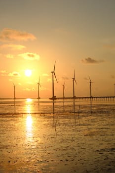 Group of wind turbines of Bac Lieu wind power plant at Mekong Delta, Vietnam. Windmill at Baclieu seaside at sunrise, make clean energy for Viet nam industry